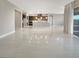 Spacious open-concept area with tile flooring, recessed lighting, and a view into the kitchen area at 3408 Isle Dr, Las Vegas, NV 89141