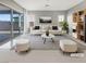 Bright living room with stylish furniture, a striped rug, and sliding glass doors for natural light at 3408 Isle Dr, Las Vegas, NV 89141