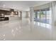 Spacious living area with modern lighting, sliding glass doors, and an adjacent open kitchen at 3408 Isle Dr, Las Vegas, NV 89141