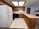 Clean kitchen with wood cabinets, tiled floor, and modern appliances at 4140 Gannet Cir # 251, Las Vegas, NV 89103