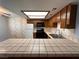 Bright kitchen features wood cabinets, tiled counters, and modern appliances at 4140 Gannet Cir # 251, Las Vegas, NV 89103
