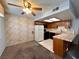 Open kitchen and dining area with wood cabinets and a ceiling fan at 4140 Gannet Cir # 251, Las Vegas, NV 89103