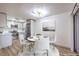 Elegant dining area with a round table and white chairs, situated next to kitchen at 5101 Village Dr, Las Vegas, NV 89142