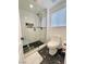 Modern bathroom with a sleek glass shower and a stylish black and white patterned floor at 540 Viva Serenade Way, Henderson, NV 89015