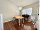 Bright dining area featuring hardwood floors, a window, and a modern light fixture at 540 Viva Serenade Way, Henderson, NV 89015