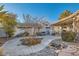Backyard featuring a fire pit, covered patio, and desert landscaping at 6019 Orca Lilly St, North Las Vegas, NV 89031
