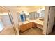 Bathroom with double sink vanity, large mirror and shower with glass door at 6019 Orca Lilly St, North Las Vegas, NV 89031