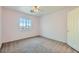 Empty bedroom with carpet floors and a window offering natural light at 6019 Orca Lilly St, North Las Vegas, NV 89031