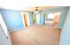 Spacious bonus room with neutral carpet, blue accent wall, and natural light at 6019 Orca Lilly St, North Las Vegas, NV 89031