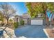 Two-story house with gray siding, white garage door, and landscaping at 6019 Orca Lilly St, North Las Vegas, NV 89031