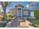 Front entrance with stone steps leading to a covered porch at 6019 Orca Lilly St, North Las Vegas, NV 89031