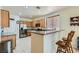 Kitchen with breakfast bar, stainless steel appliances, and wood cabinets at 6019 Orca Lilly St, North Las Vegas, NV 89031