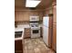 Eat-in kitchen featuring essential appliances and lots of light cabinets at 3046 Tarpon Dr # 103, Las Vegas, NV 89120