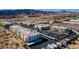Wide aerial shows a community with multiple units, covered parking, a tennis court, and tidy landscaping at 3550 Bay Sands Dr # 2076, Laughlin, NV 89029