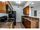 This is a warm kitchen with wood cabinets, granite countertops, and black appliances at 3550 Bay Sands Dr # 2076, Laughlin, NV 89029