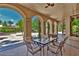 Covered patio with arched entryways and seating for dining at 5079 Mountain Top Cir, Las Vegas, NV 89148