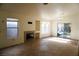 Spacious living area with tile floors, fireplace, and sliding glass door at 5467 Morning Swim Ln, Las Vegas, NV 89113