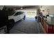 Garage interior with epoxy flooring, storage and parked SUV at 6843 Toros St, North Las Vegas, NV 89086