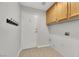 Laundry room with wood cabinets and exterior access at 686 Covina Dr, Henderson, NV 89002