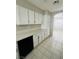 White kitchen cabinets, granite countertops and tile floors at 1509 Blanco Dr, North Las Vegas, NV 89031
