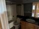 Clean bathroom with a tub, toilet, vanity with dark countertop and mirror at 1531 Singing Bird Ln, North Las Vegas, NV 89031