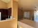 Open concept kitchen with breakfast bar, dark wood cabinets, and view to dining area at 1531 Singing Bird Ln, North Las Vegas, NV 89031