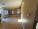 Spacious living room with hardwood floors, neutral walls, and a view to kitchen at 1531 Singing Bird Ln, North Las Vegas, NV 89031