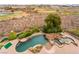 Aerial view showcases a stunning pool, putting green, lush landscaping, and an expansive golf course backdrop at 2870 Quartz Canyon Dr, Henderson, NV 89052
