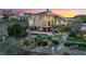 Luxury home with pool and landscaped grounds, offering stunning sunset views at 2870 Quartz Canyon Dr, Henderson, NV 89052