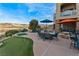 Expansive backyard features a patio, putting green, and comfortable outdoor seating area overlooking the golf course at 2870 Quartz Canyon Dr, Henderson, NV 89052