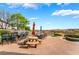 Stunning backyard showcases a well-equipped bar, outdoor seating, serene lake views, and putting green at 2870 Quartz Canyon Dr, Henderson, NV 89052