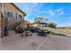 Backyard with stairs to the patio and putting green, stone seating, and well-maintained landscaping at 2870 Quartz Canyon Dr, Henderson, NV 89052