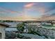 Backyard view of the pool, golf course, and desert landscape at sunset at 2870 Quartz Canyon Dr, Henderson, NV 89052