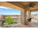 Brick balcony featuring a ceiling fan, seating, and views of the golf course and water feature at 2870 Quartz Canyon Dr, Henderson, NV 89052
