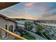 Scenic balcony view showcasing a putting green and picturesque landscaping at sunset at 2870 Quartz Canyon Dr, Henderson, NV 89052