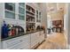 Elegant bar area with custom cabinets, display shelves, and ample counter space for entertaining at 2870 Quartz Canyon Dr, Henderson, NV 89052