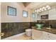 Elegant powder room featuring a modern glass sink, decorative wall tiles, and unique vanity lighting at 2870 Quartz Canyon Dr, Henderson, NV 89052