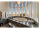 Close-up of primary bath tub showcasing large windows with golf course and mountain views at 2870 Quartz Canyon Dr, Henderson, NV 89052