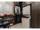 Walk-in closet featuring custom cabinets, shelves, and stacked washer and dryer at 2870 Quartz Canyon Dr, Henderson, NV 89052