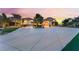 Elegant home featuring a large driveway and porte cochere that leads to a beautiful home and landscaped entryway at 2870 Quartz Canyon Dr, Henderson, NV 89052