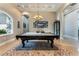 Spacious game room with a pool table, decorative rug, chandelier, and bright windows at 2870 Quartz Canyon Dr, Henderson, NV 89052