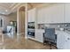 Bright kitchenette area with built-in appliances, white cabinets, and a comfortable workspace at 2870 Quartz Canyon Dr, Henderson, NV 89052