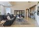 Open living room with stone fireplace, high ceilings, elegant rug, and view of exterior patio at 2870 Quartz Canyon Dr, Henderson, NV 89052