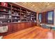 Spacious home office with custom built-in shelving, hardwood floors and natural light at 2870 Quartz Canyon Dr, Henderson, NV 89052