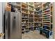Walk-in pantry featuring ample shelving, food storage, and a stainless steel refrigerator at 2870 Quartz Canyon Dr, Henderson, NV 89052
