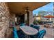 Charming covered patio with ample seating, offering a cozy spot for relaxation and outdoor dining at 2870 Quartz Canyon Dr, Henderson, NV 89052