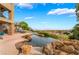 Resort-style pool with serene views of the lake, lush greenery, and a tranquil backyard setting at 2870 Quartz Canyon Dr, Henderson, NV 89052