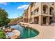 Resort-style backyard features a stunning pool, rock features, and a beautifully designed exterior with stone accents at 2870 Quartz Canyon Dr, Henderson, NV 89052