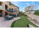 Lush backyard featuring a putting green, patio with dining set, and meticulously landscaped surroundings at 2870 Quartz Canyon Dr, Henderson, NV 89052