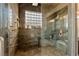 Walk-in shower with luxurious finishes, a built-in seat, and a glass block window for privacy at 2870 Quartz Canyon Dr, Henderson, NV 89052